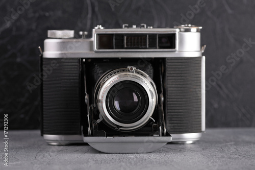 The vintage medium format rangefinder camera on cement background.