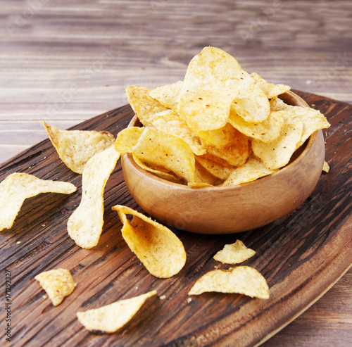 Chips in a wooden bowl on table