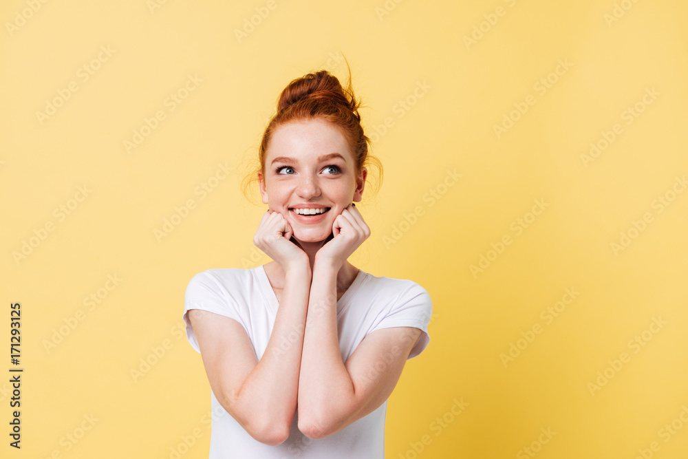 Smiling woman in t-shirt reclines on hands and looking away Smiling woman in t-shirt reclines on hands and looking away