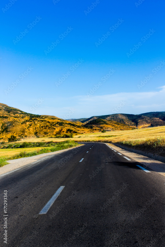 road through the mountain ,summer time ,sunny day ,blue sky