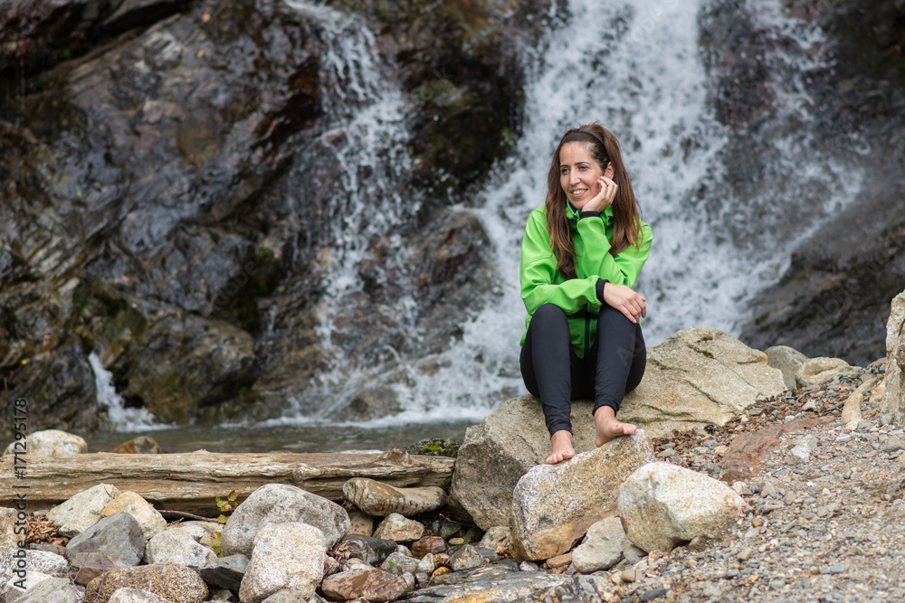 woman enjoying near a waterfall