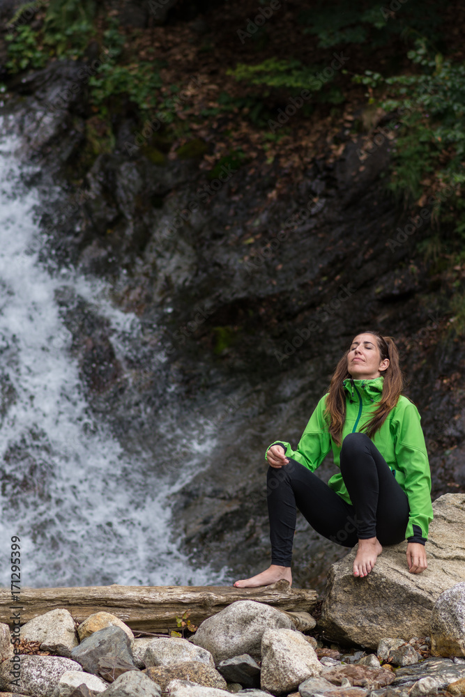 woman enjoying near a waterfall