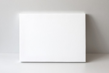 White empty canvas. Gray wall on background. Mock up poster frame, canvas template.
