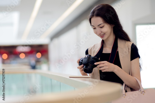 Young beautiful woman photographer, in the interior of the store