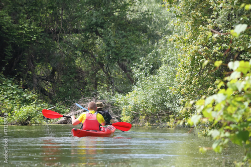 Man paddling in red kayak in Danube river biosphere reserve