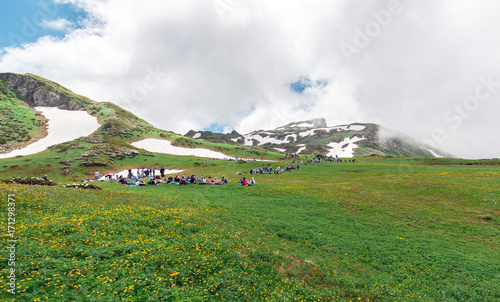 A lot of tourists have a rest at ascension on mountain top photo