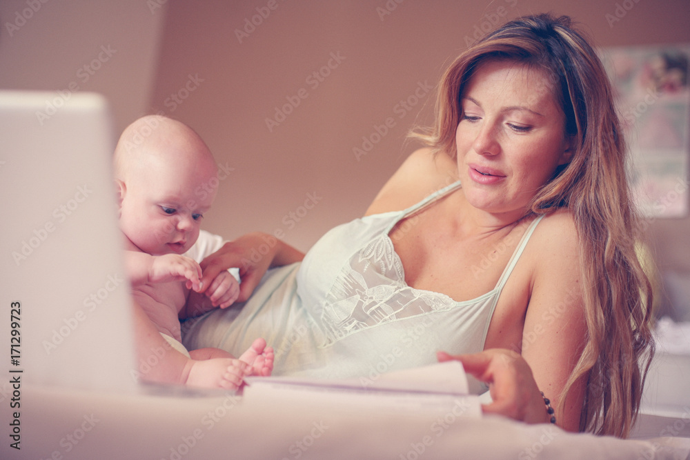 Mother and her little baby at home. Mother working at home. Mother and her little baby at home. Mother working at home.