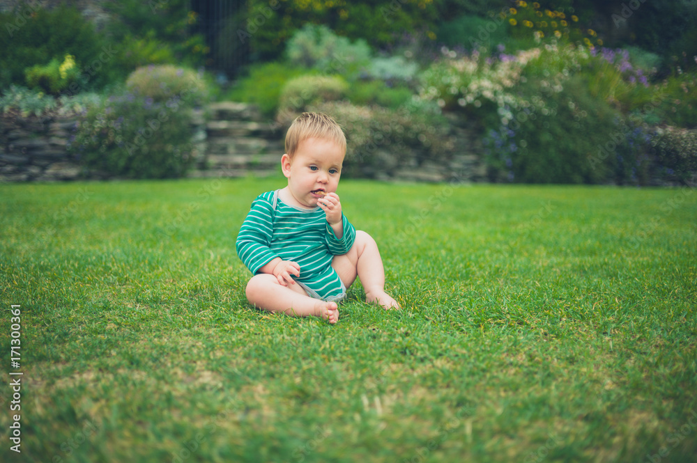 Little baby sitting on a lawn Little baby sitting on a lawn