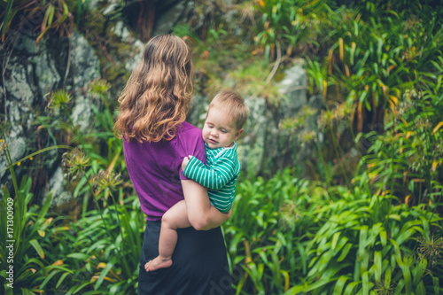 Mother holding baby in nature