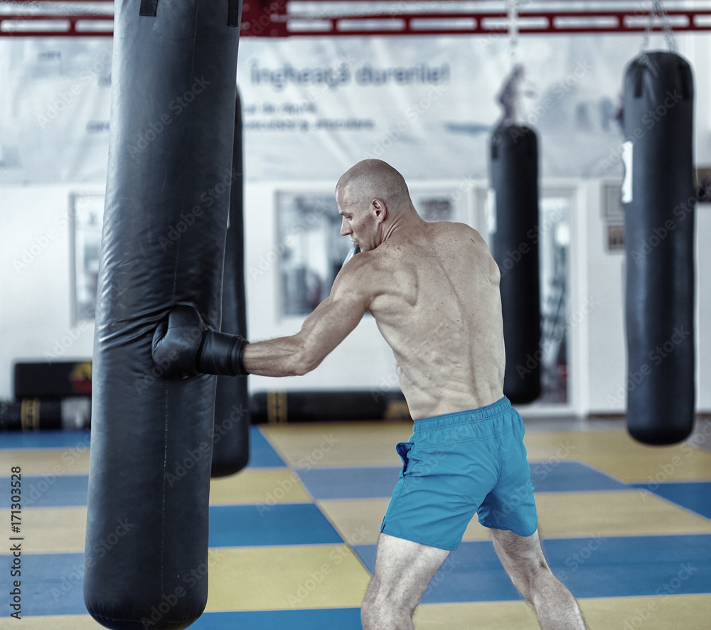 Kickbox fighter training with the punch bag