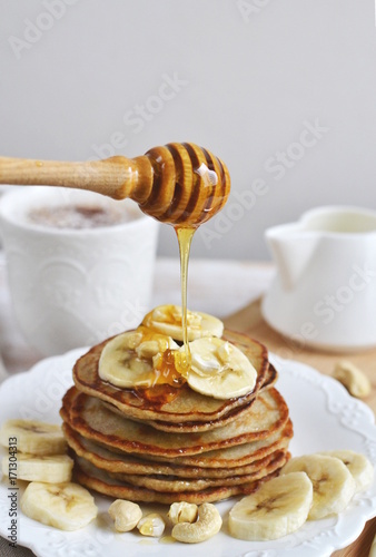 Homemade Banana Cashew Pancakes Honey Sauce Milk Flour Wooden Table Kitchen Towel Cutlery 