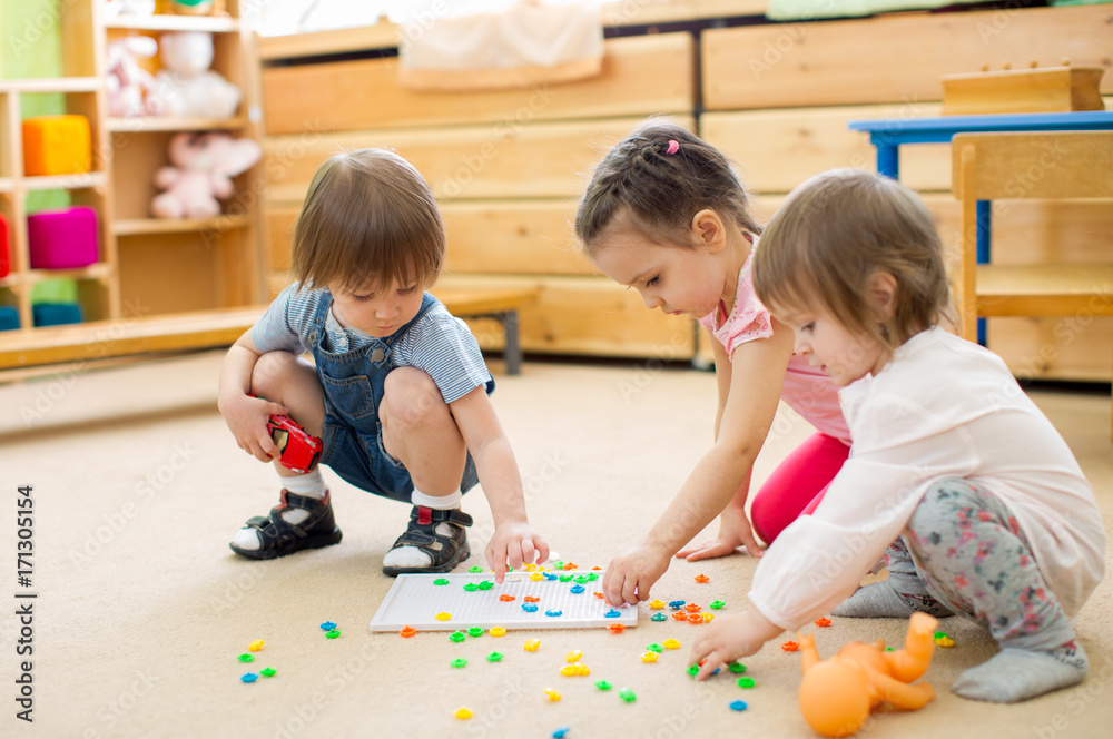 kids group playing mosaic game in kindergarten kids group playing mosaic game in kindergarten