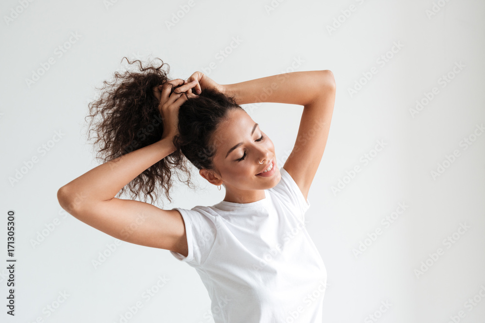 Smiling pretty girl with eyes closed playing with her hair Smiling pretty girl with eyes closed playing with her hair