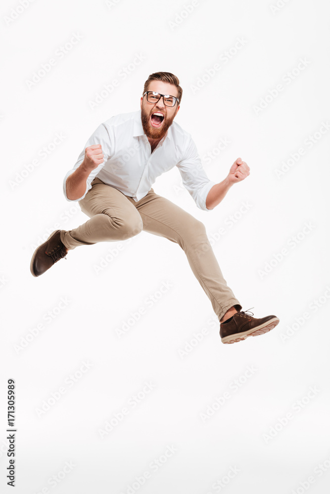 Cheerful young bearded man jumping