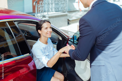 Photography Cheerful nice businesswoman getting out of the car