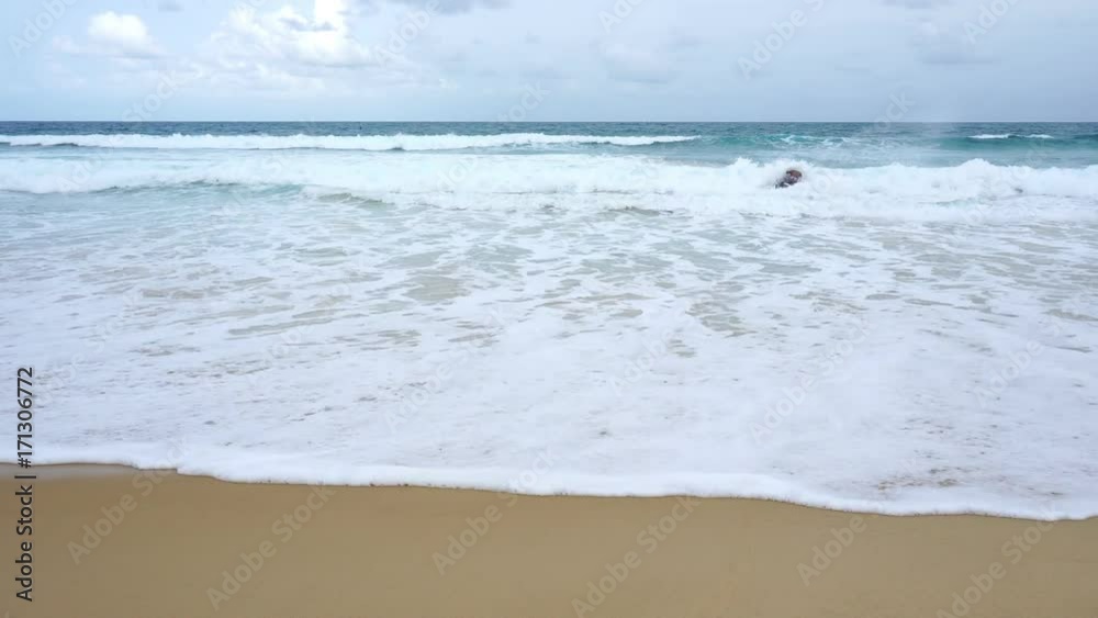 young man riding jet ski on andaman sea in phuket thailand with wave crashing on sandy shore young man riding jet ski on andaman sea in phuket thailand with wave crashing on sandy shore