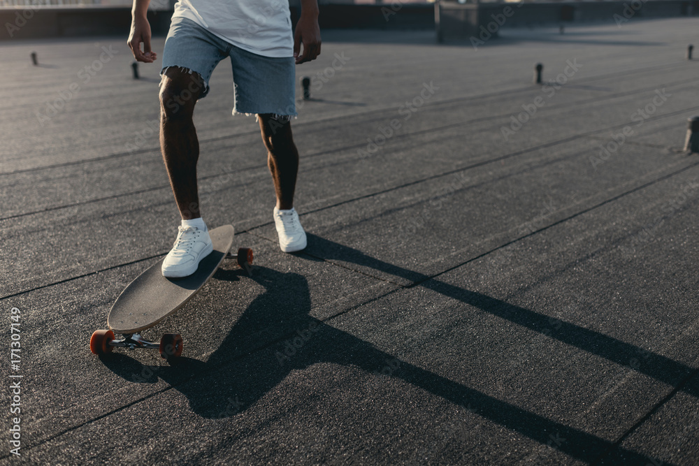 Fototapeta premium man riding on skateboard on rooftop
