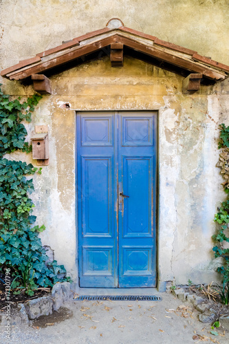wooden door in an italian village © cmnaumann