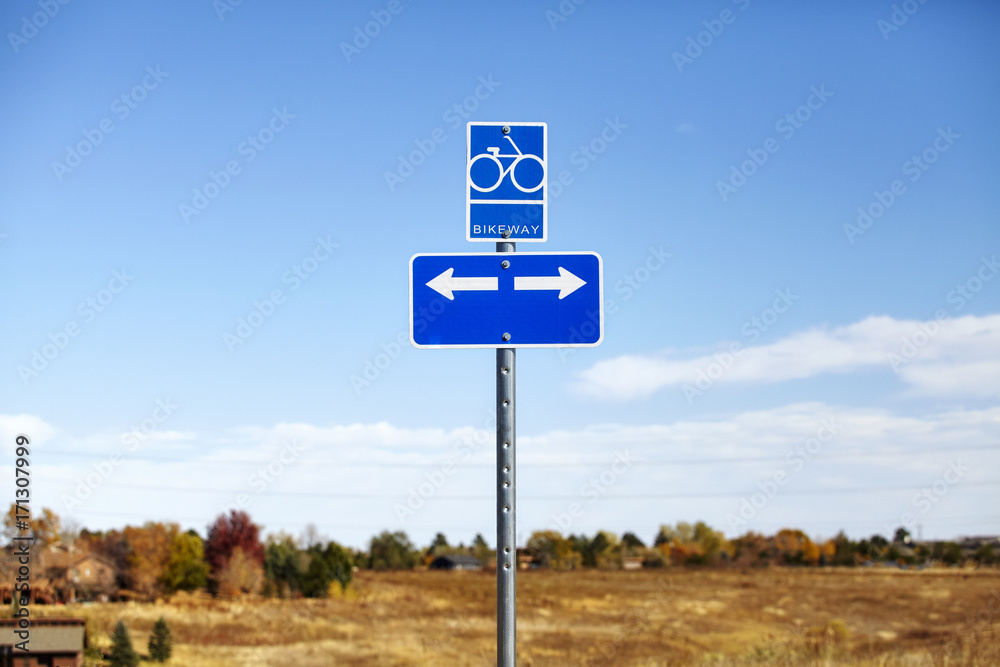 Bikeway road sign against blue sky, choice concept.
Bikeway road sign against blue sky, choice concept.
