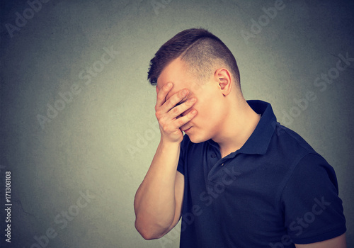 Sad depressed man looking down photo