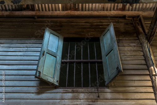 Antique wooden window of the abonaded  house.