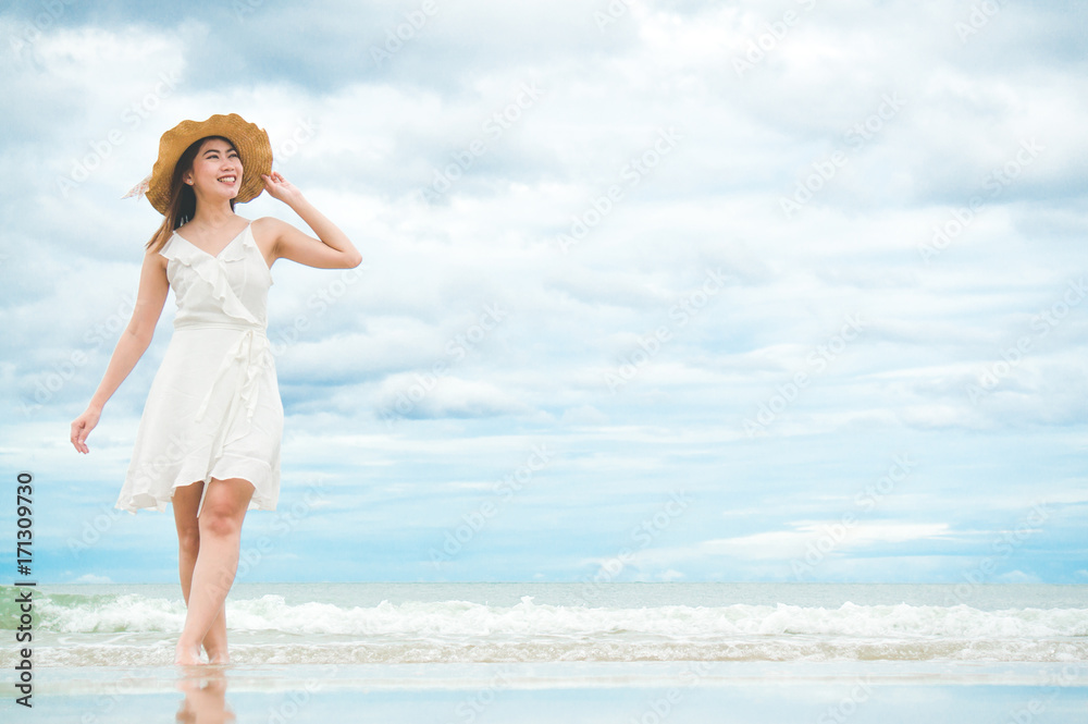 Asian woman feeling relax on beach with blue sky and sea in holiday vacation summer Asian woman feeling relax on beach with blue sky and sea in holiday vacation summer