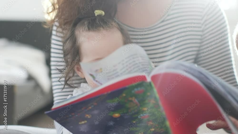 Happy family at home mother and father reading their daughter Happy family at home mother and father reading their daughter