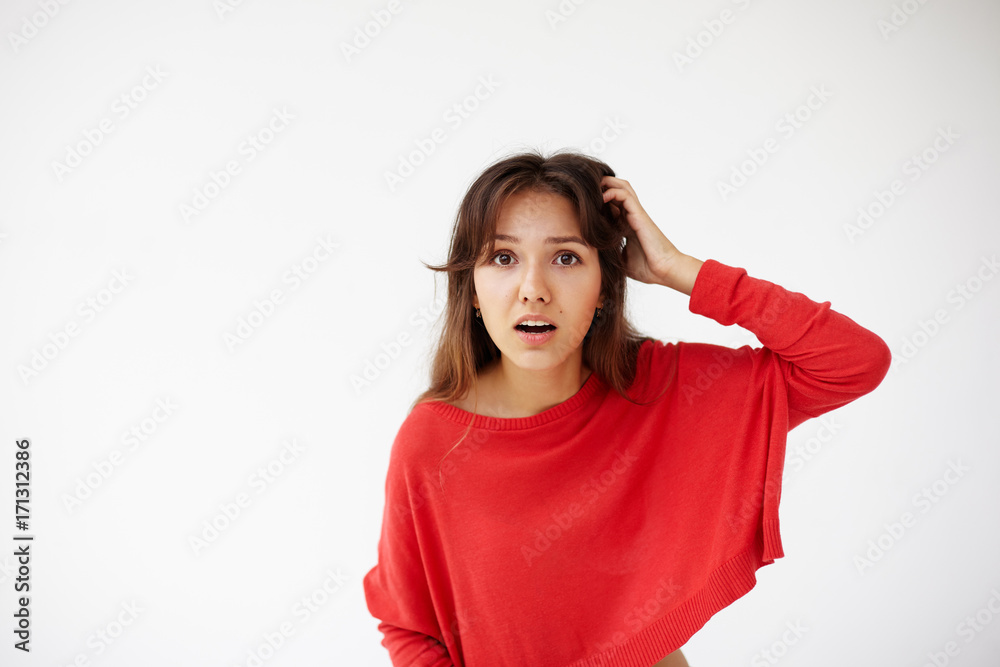 Headshot portrait of ingenious young woman in red sweater holding hand on nape remembered something important. Body language, facial expressions and emotions Headshot portrait of ingenious young woman in red sweater holding hand on nape remembered something important. Body language, facial expressions and emotions