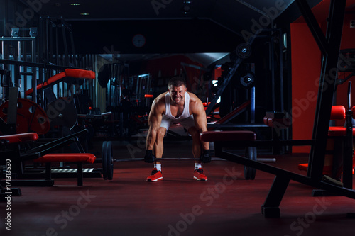 Young man exercising with weight in the gym. © Zoran Zeremski