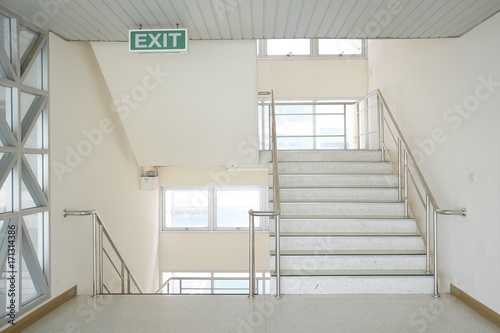 Building stairs and green exit signs.