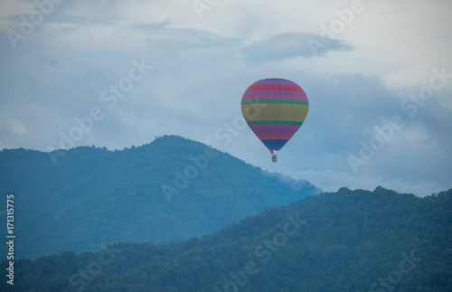 Balloons, sky, clouds and mountains in the morning, isubject is blurred.