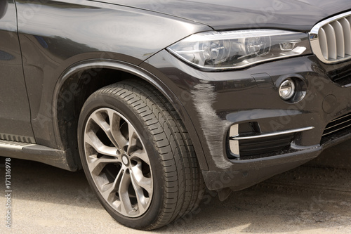 Brand new black SUV car get scratched car bumper damaged in collision © fotovapl