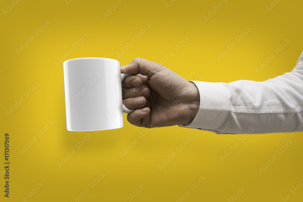 Hand in white shirt is holding white cup mock-up Hand in white shirt is holding white cup mock-up