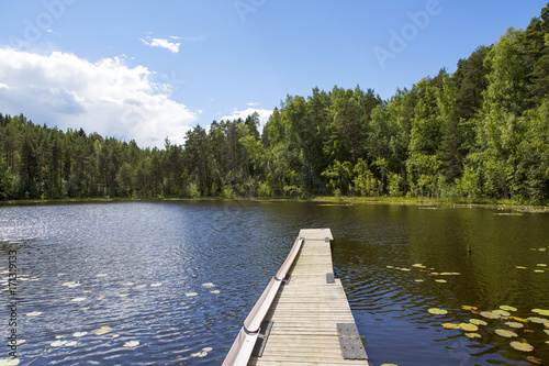 Traditional landscape from Finland during the summer day. Wooden pier by the lake.