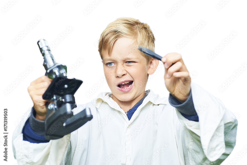 Adorable child school blond boy prepares to examine insect under the microscope. Isolated on white background. Concept of young scientist Adorable child school blond boy prepares to examine insect under the microscope. Isolated on white background. Concept of young scientist