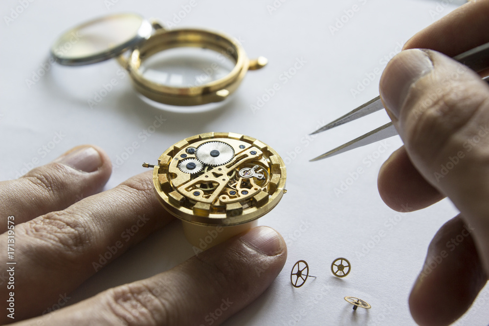 Watchmaker is repairing the mechanical watches in his workshop Watchmaker is repairing the mechanical watches in his workshop