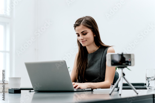 Female vlogger recording content for her video blog. photo