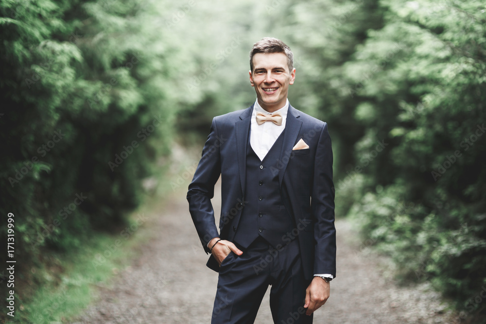 Young handsome man posing on mountain forest Young handsome man posing on mountain forest