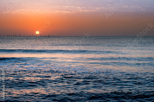 Golden sunrise sunset over the sea ocean waves