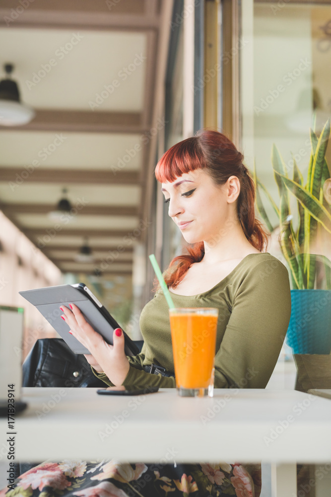 young woman beautiful outdoor using tablet hand hold - technlogy, social network, communication concept young woman beautiful outdoor using tablet hand hold - technlogy, social network, communication concept