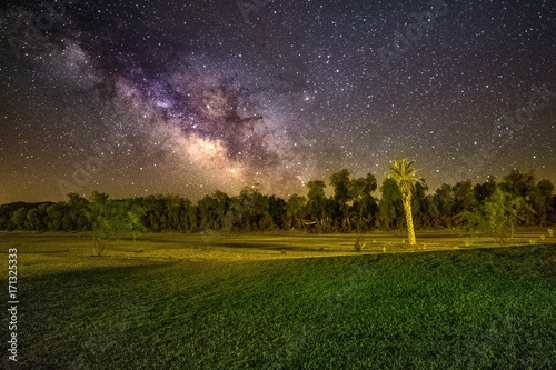 The Milky Way brings the sky to life on the Furnace creek golf course in Death Valley national park.  photo