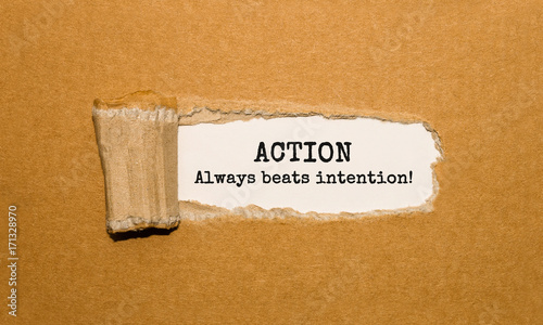 Картината върху платно The text Action Always beats intention appearing behind torn brown paper