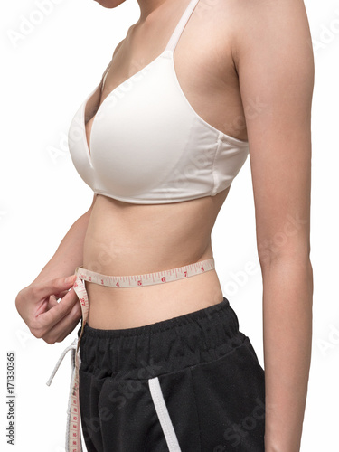 Close up of female body measuring her waist on white background, diet and healthy lifestyle