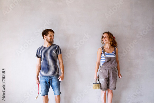 Young couple in love painting walls in their new home. © Halfpoint