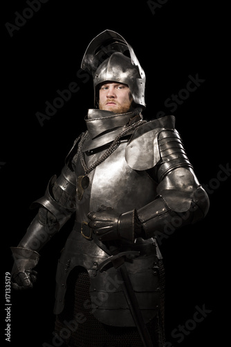 Canvas Print Knight in armour after battle on the black background