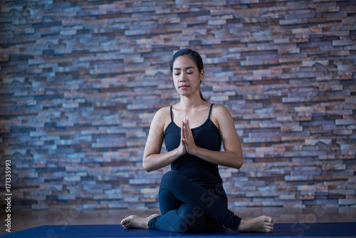 Young woman in yoga series on prayer and meditation is in the studio the gym.
