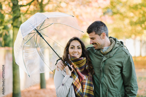 Lovely young couple in love at the park in autumn. Romantic man and woman portrait.