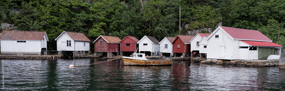 Fototapeta premium Norwegian boathouses. These days many of these buildings have been converted to cabins, but these seems to for the boats.