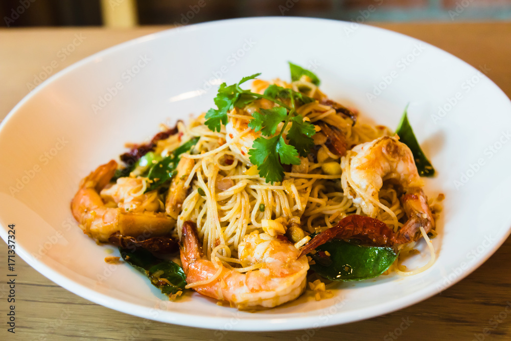 Spicy stir fried spaghetti seafood on white dish Spicy stir fried spaghetti seafood on white dish