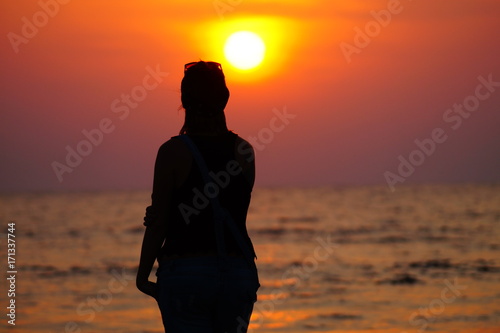 Female doing yoga on the sunset, asana pose, silhouette of the young girl, freedom moments